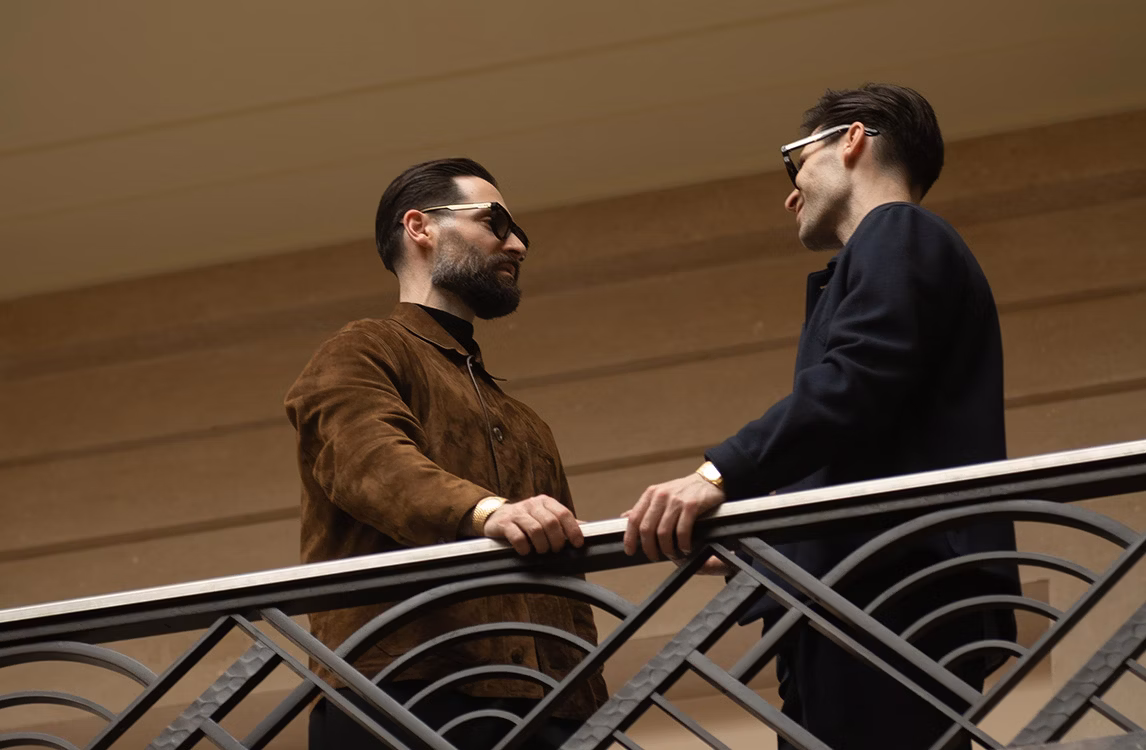 Ryan and Adam Goldston in conversation on the Art Deco balcony of Villa Empain, Brussels.