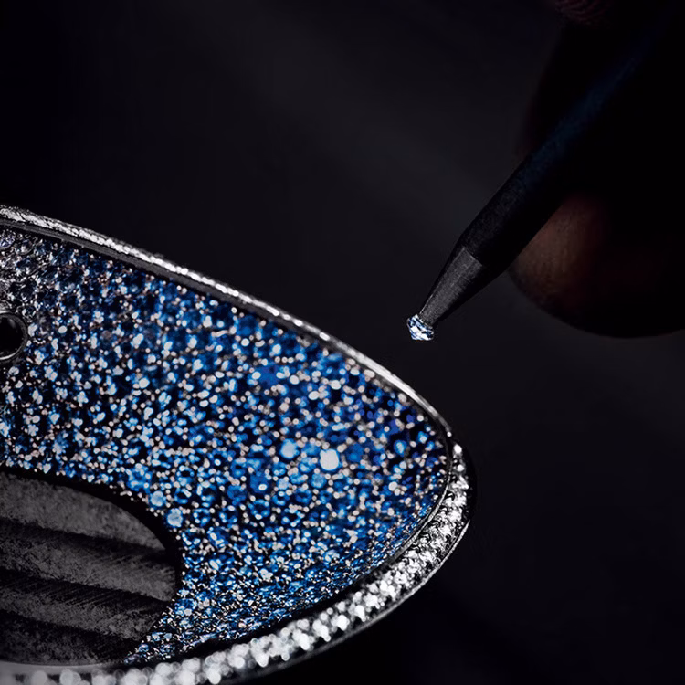 Gem-setter working at the Métiers d'Art Atelier in the museum Musée Atelier Audemars Piguet, Le Chenit, Switzerland.