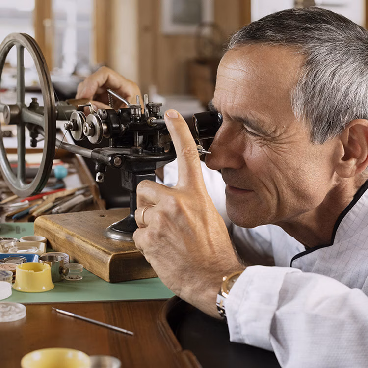 Watchmaker working at the Restoration Atelier in the museum Musée Atelier Audemars Piguet, Le Chenit, Switzerland.