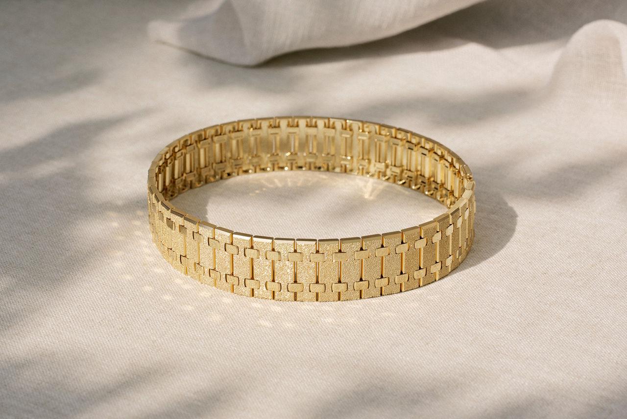 Lifestyle shot of the Audemars Piguet Summer Haze necklace resting on fabric. 