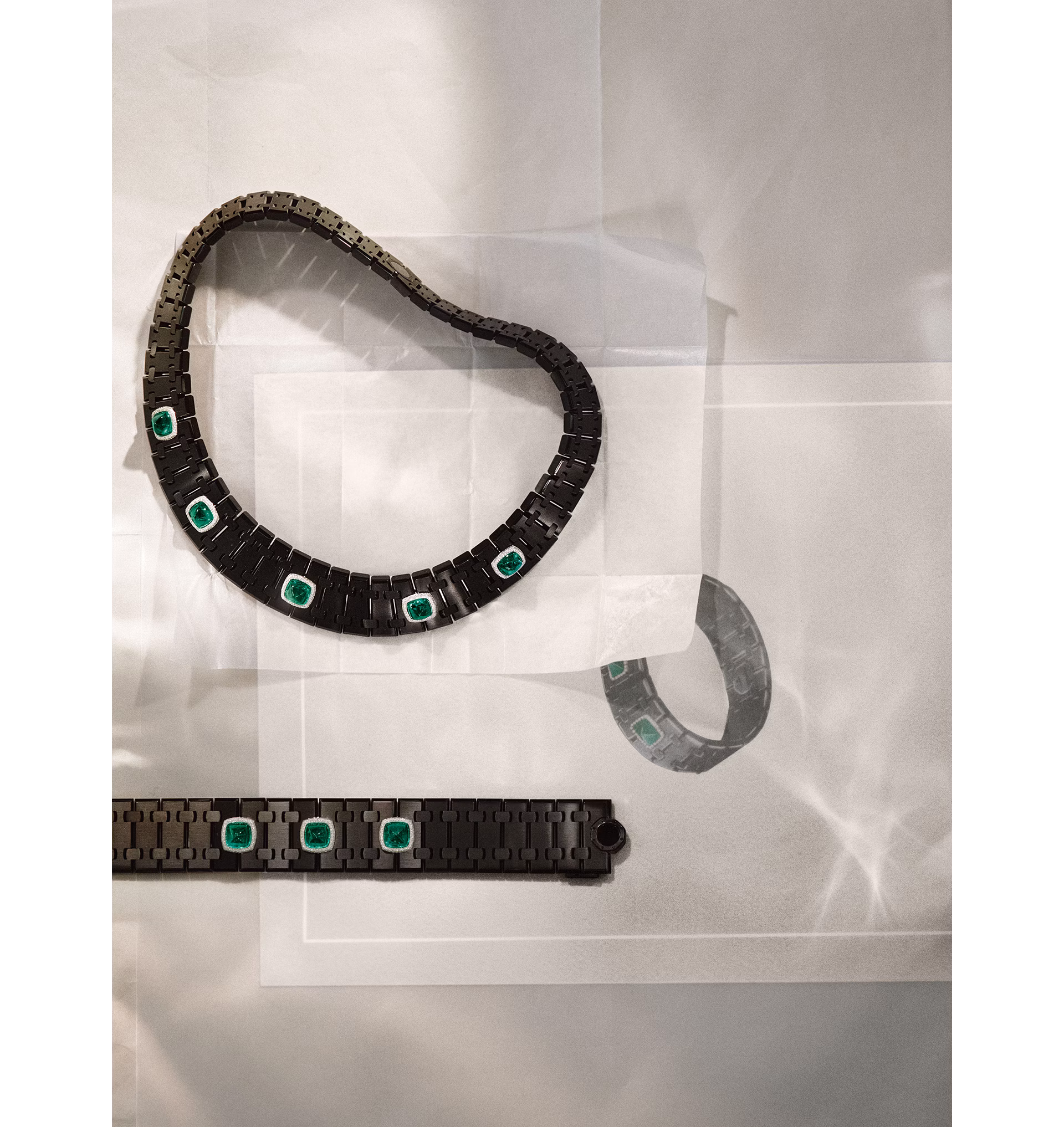 Risoud Eclipse Choker and Risoud Eclipse Cuff in black ceramic, set with emeralds surrounded by diamonds, from the Royal Oak Joaillerie collection.