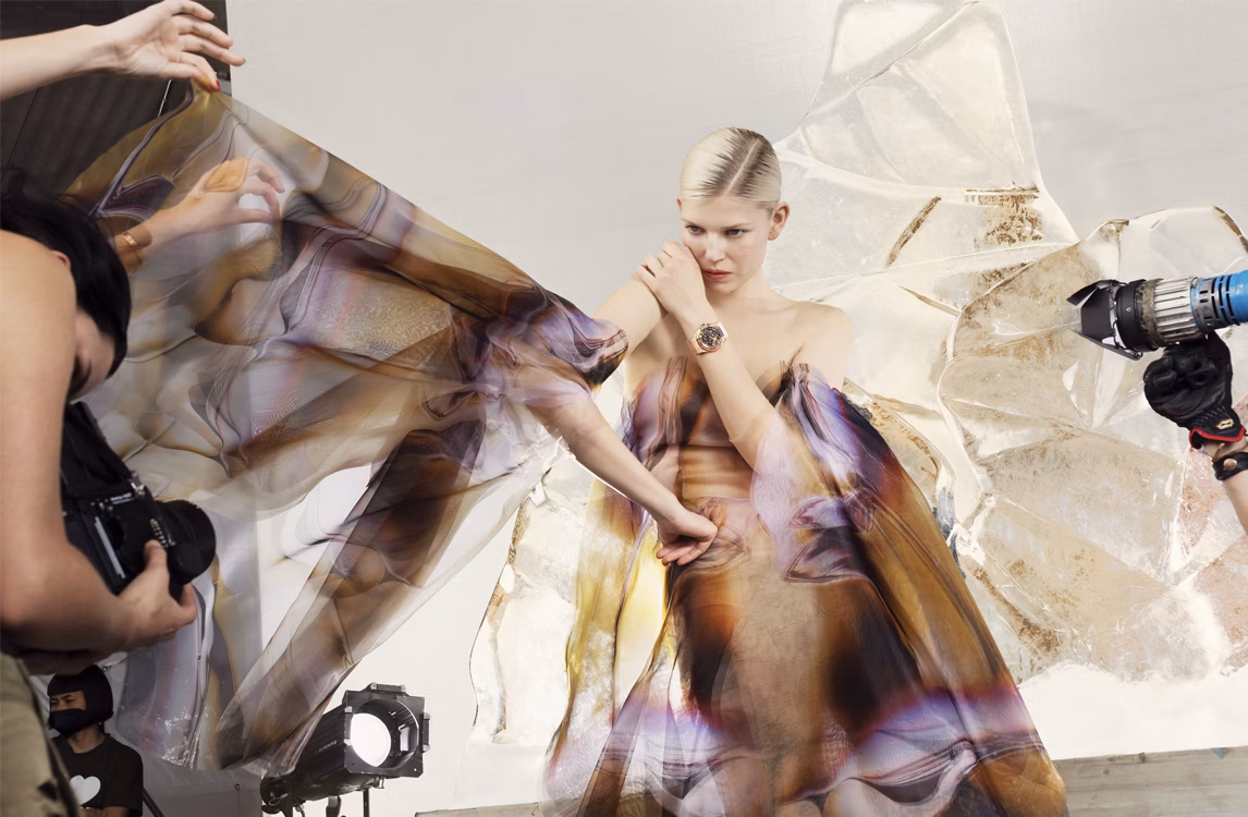 Harley Weir photographing a model wearing a Royal Oak Frosted Gold Double Balance Wheel Openworked