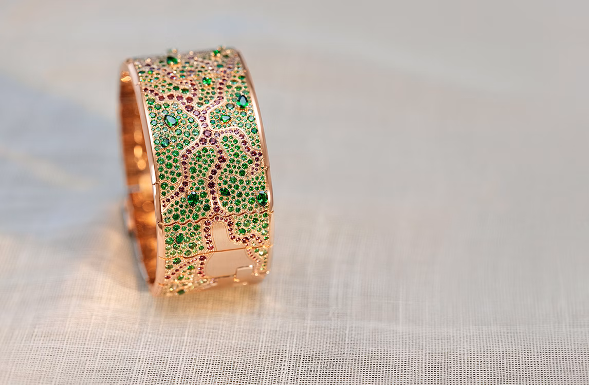 Lifestyle shot of the Audemars Piguet Tree of Life bracelet resting on fabric.