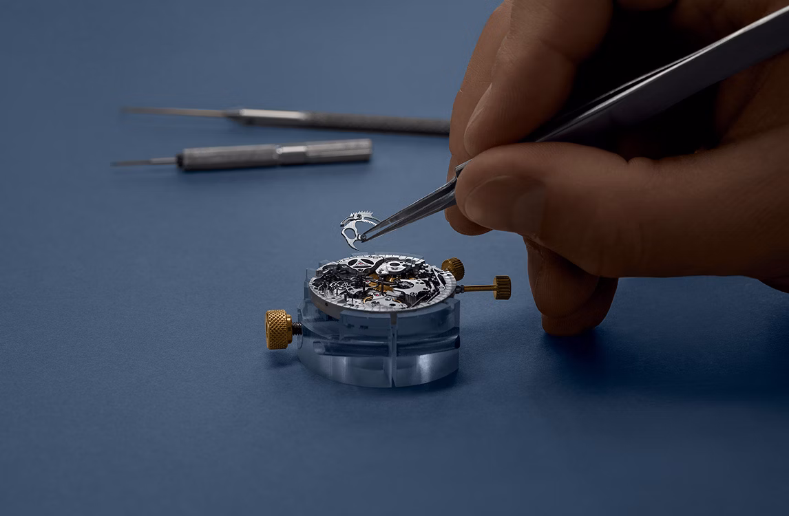 A watch being assembled by a watchmaker.
