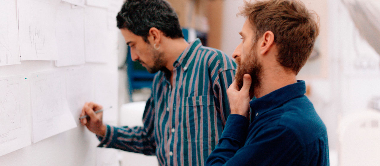 The artists Petrit Halilaj and Álvaro Urbano working on their project in a workshop.