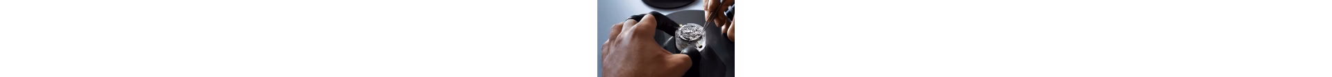 Close-up of a watchmaker working on a timepiece.
