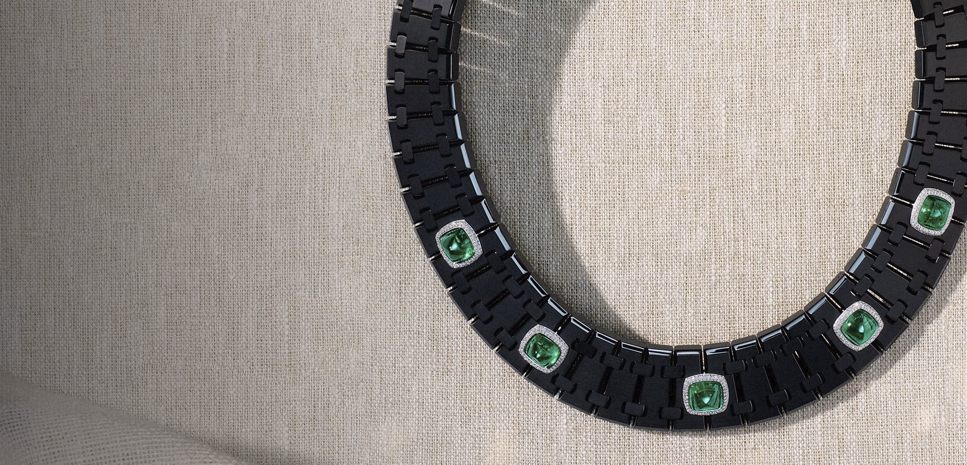 Lifestyle shot of the Audemars Piguet Risoud Eclipse necklace resting on fabric.